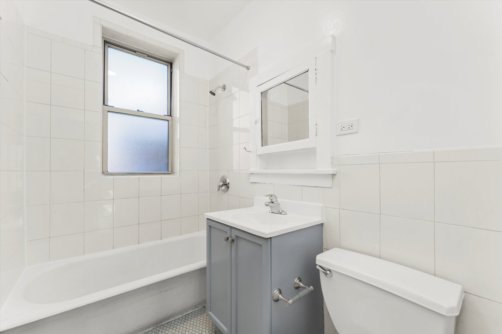 4744 West Roscoe Street, Unit 2 Chicago, IL 60641 - Photo 11 of 14 a bathroom with a sink toilet and bathtub