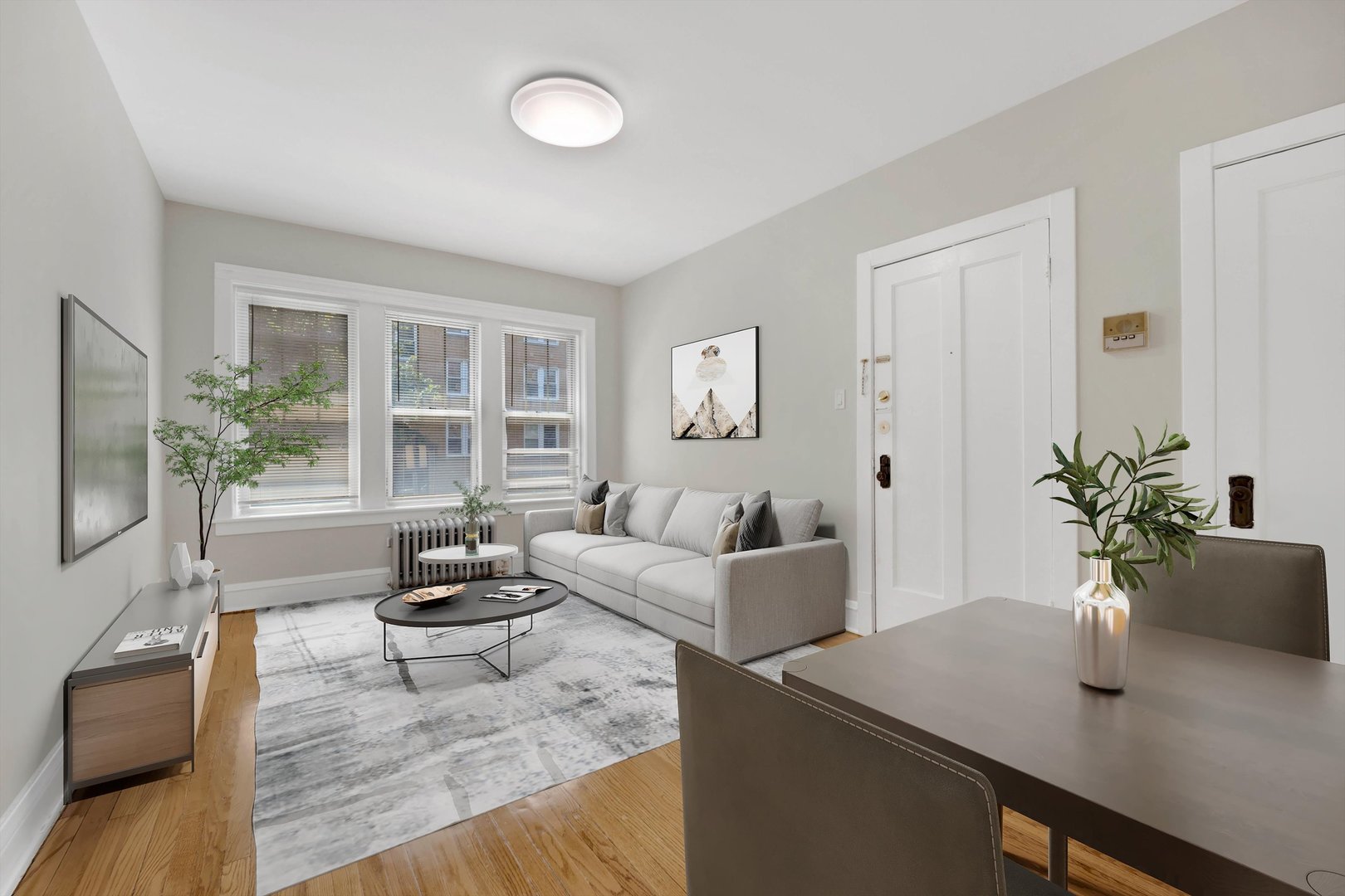 4744 West Roscoe Street, Unit 2 Chicago, IL 60641 - Photo 2 of 14 a living room with furniture and a potted plant
