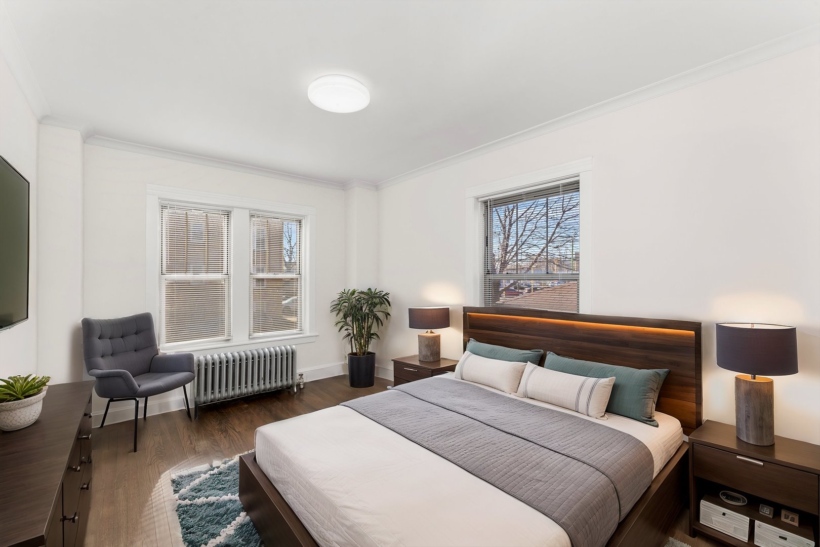 4744 West Roscoe Street, Unit 2 Chicago, IL 60641 - Photo 8 of 14 a bedroom with furniture and a window