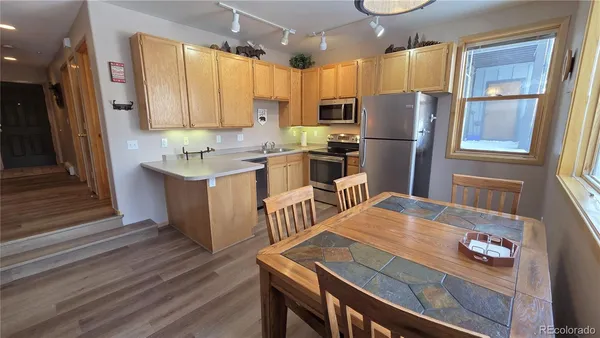 a kitchen with refrigerator cabinets dining table and chairs