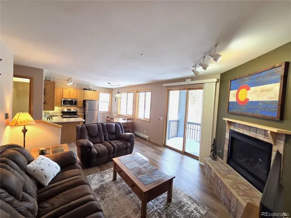 a living room with furniture a flat screen tv and a fireplace
