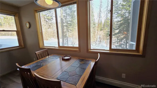 a view of a dining room with furniture and windows