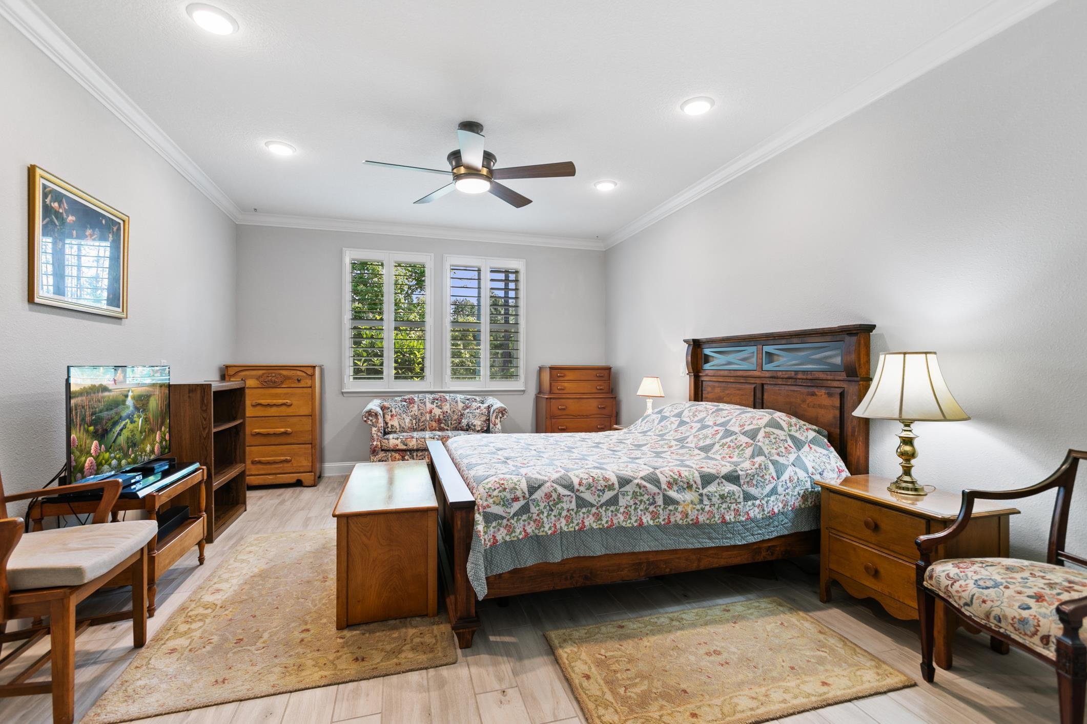 106 Key Grass Court St. Johns, FL 32259 - Photo 22 of 98 a bedroom with a bed a lamp and a flat screen tv