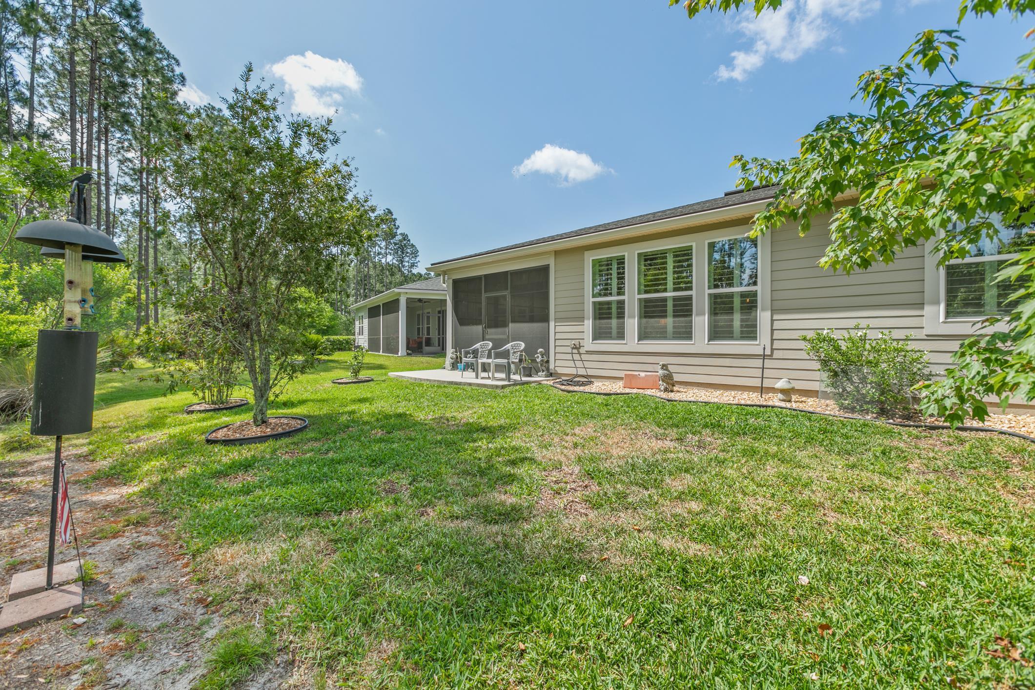 106 Key Grass Court St. Johns, FL 32259 - Photo 50 of 98 a front view of a house with a yard and potted plants