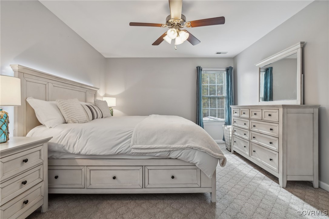 1121 Coachpoint Road Hartfield, VA 23071 - Photo 19 of 46 Bedroom featuring ceiling fan and carpet