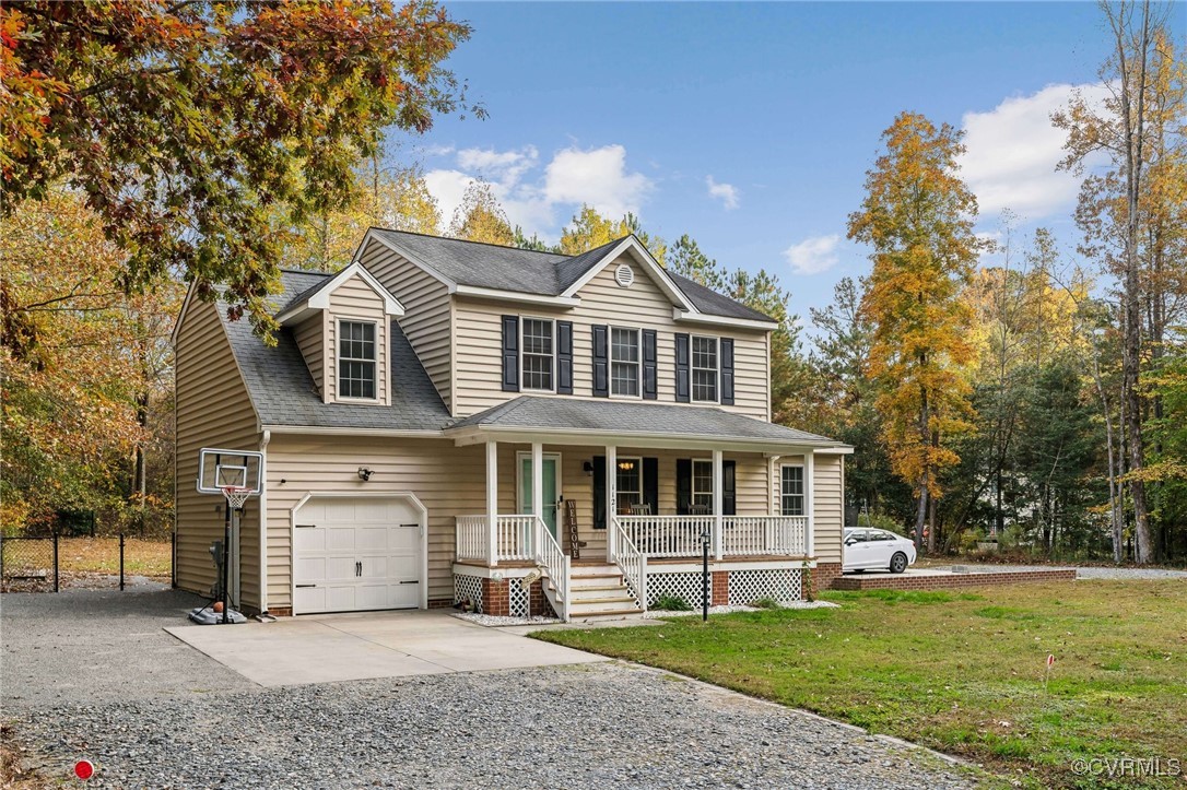 1121 Coachpoint Road Hartfield, VA 23071 - Photo 2 of 46 View of front of property featuring a garage, a po