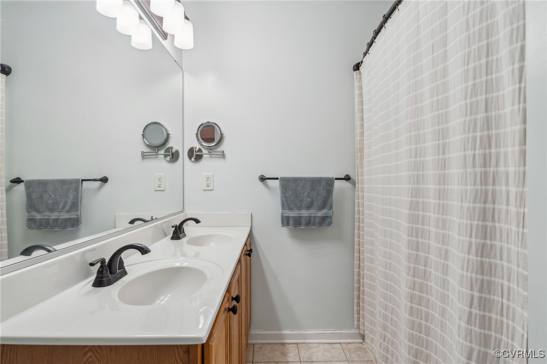 1121 Coachpoint Road Hartfield, VA 23071 - Photo 22 of 46 Bathroom featuring vanity and tile patterned floor