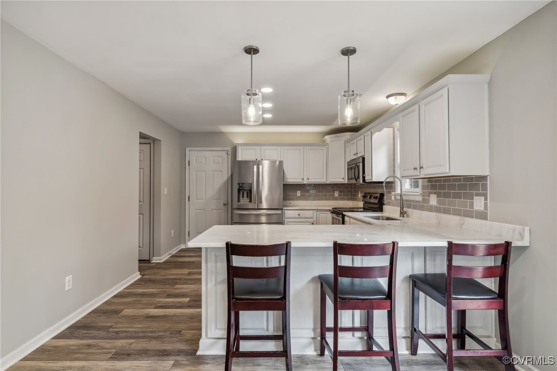 1121 Coachpoint Road Hartfield, VA 23071 - Photo 7 of 46 Kitchen featuring white cabinetry, appliances with