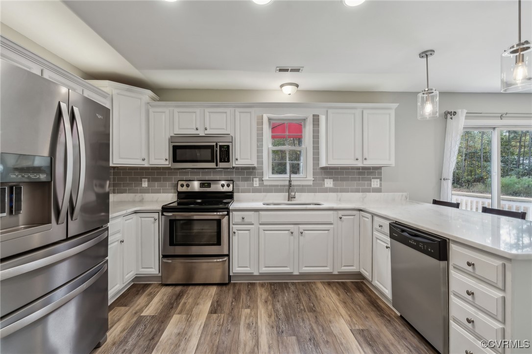 1121 Coachpoint Road Hartfield, VA 23071 - Photo 8 of 46 Kitchen featuring stainless steel appliances, hang