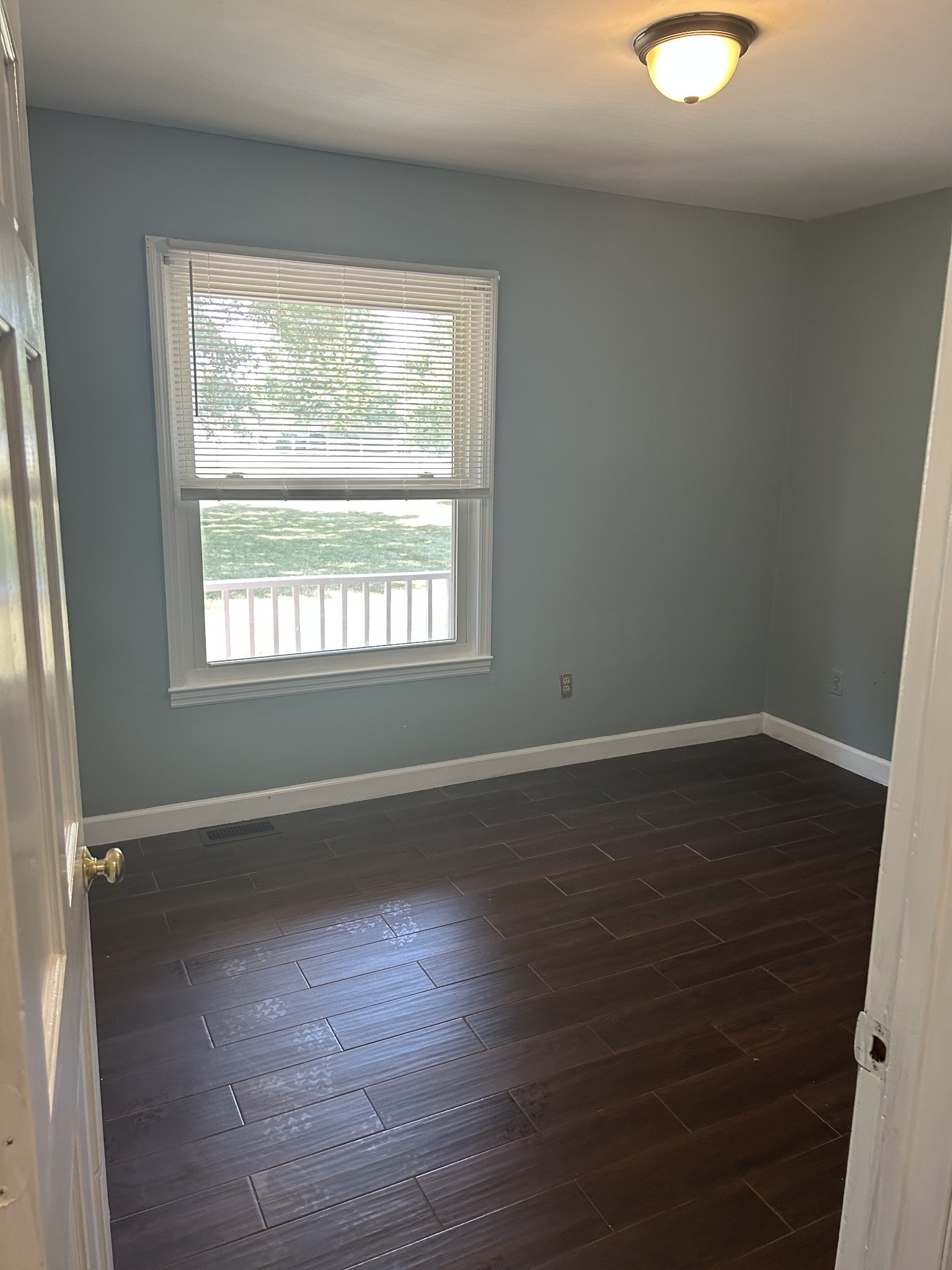 4264 Port Royal Road Spring Hill, TN 37174 - Photo 6 of 14 a view of an empty room with wooden floor and a window