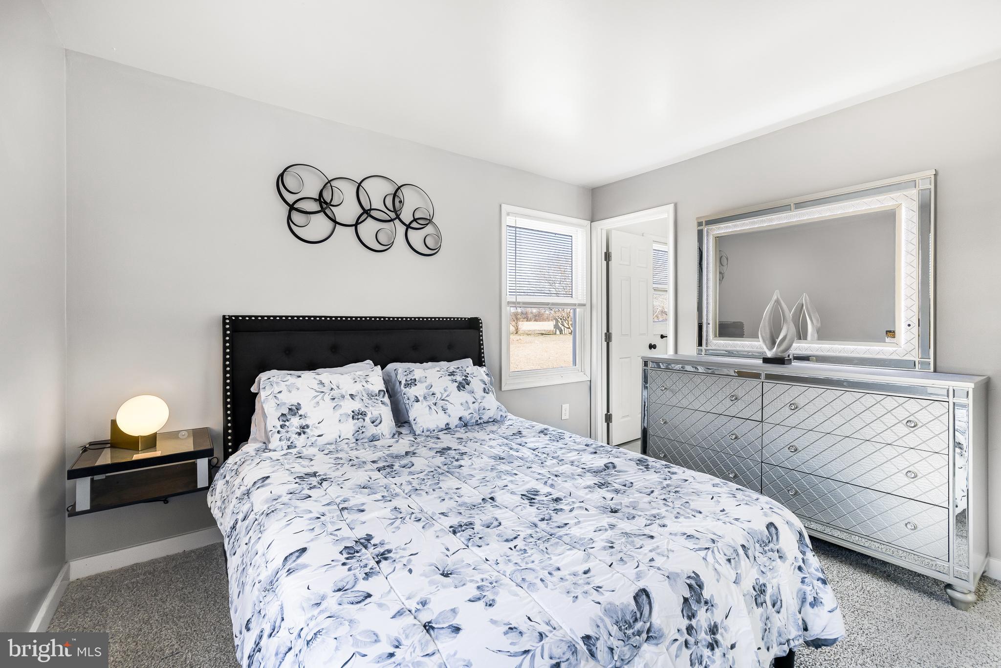 22041 Neal Road Lincoln, DE 19960 - Photo 20 of 28 a bedroom with a bed and a mirror on dresser