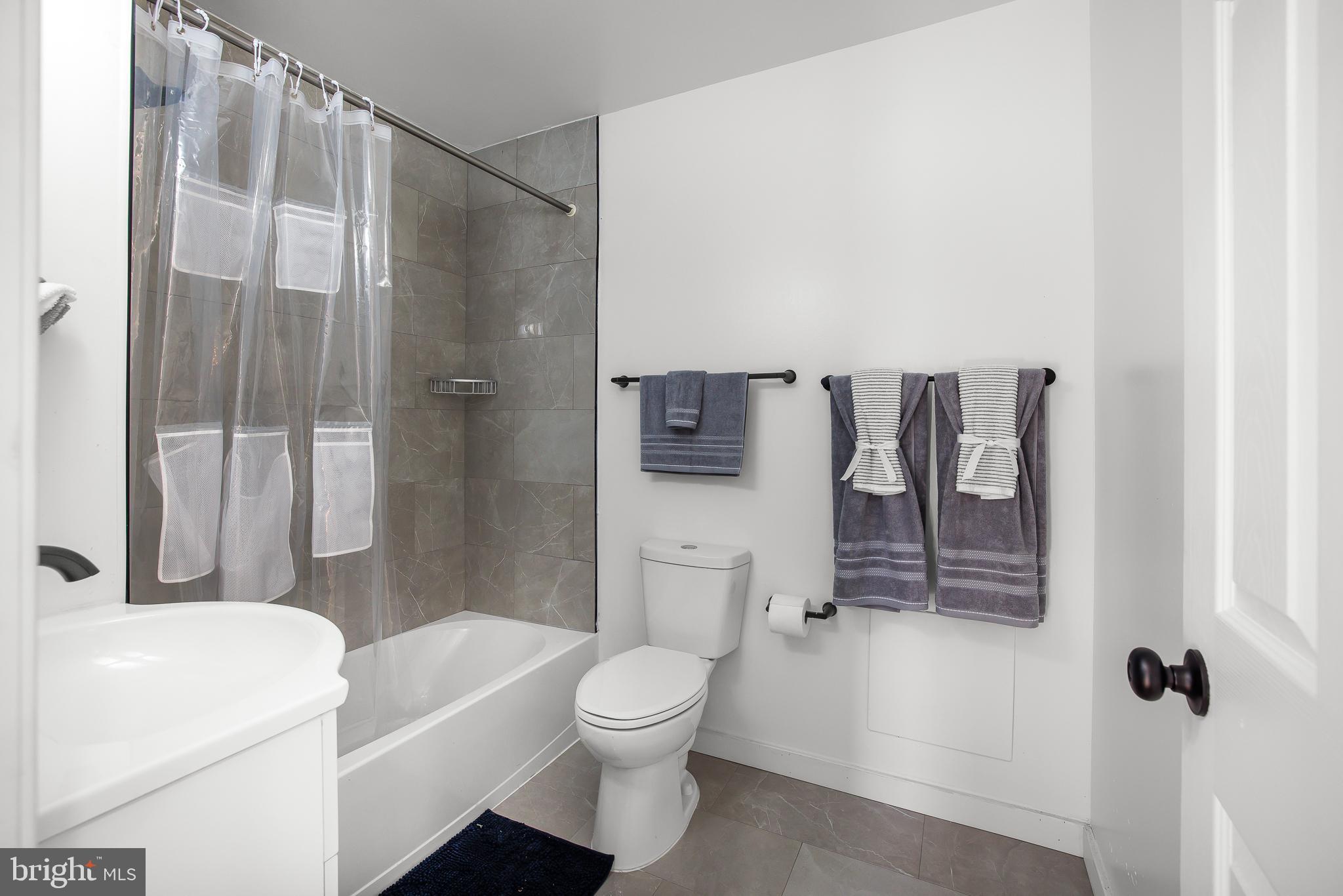 22041 Neal Road Lincoln, DE 19960 - Photo 22 of 28 a bathroom with a toilet a sink and shower