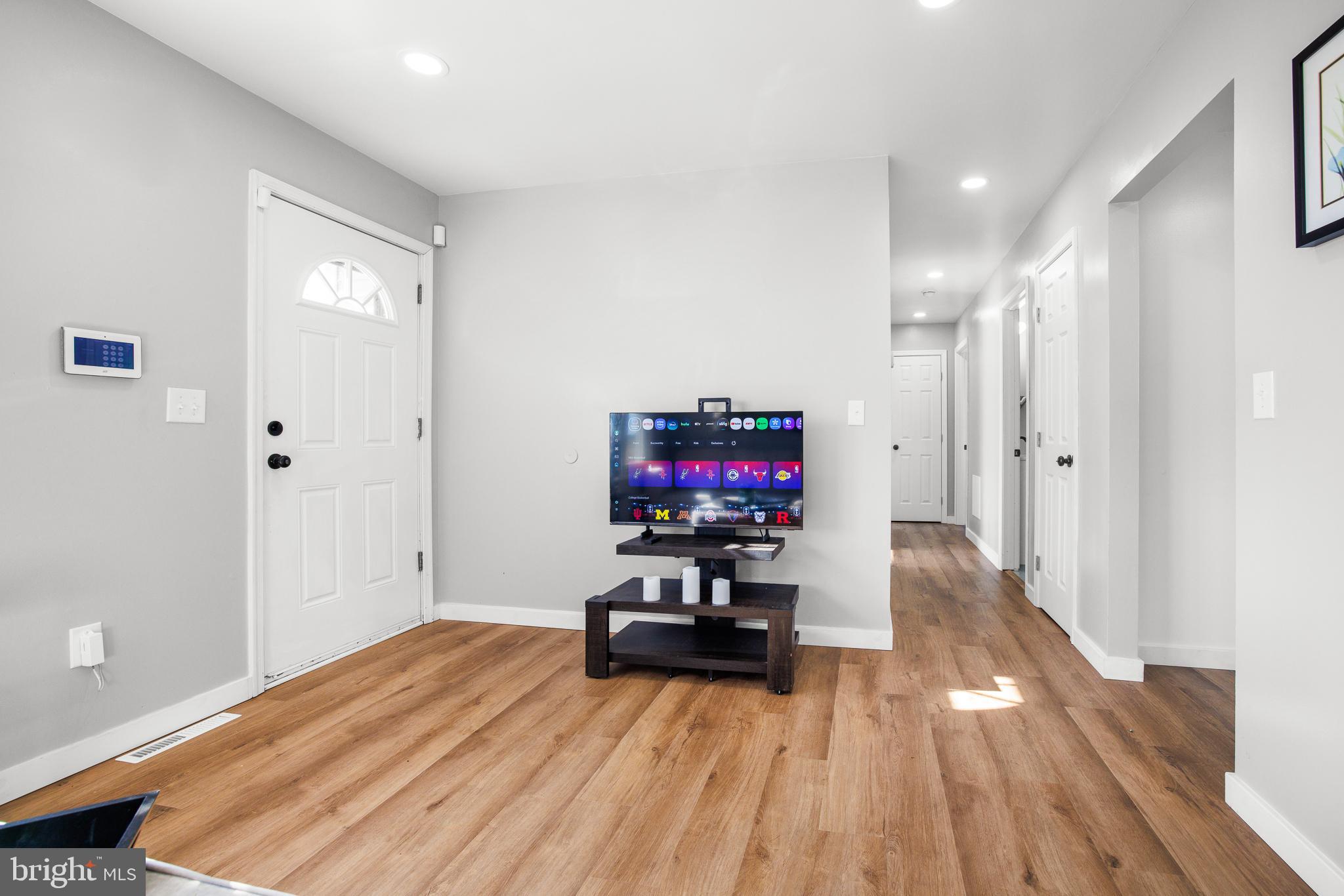 22041 Neal Road Lincoln, DE 19960 - Photo 7 of 28 a hallway with a bed and a flat screen tv