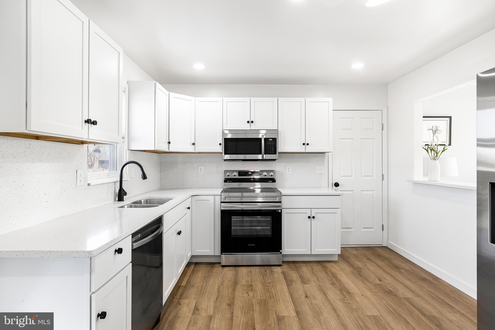 22041 Neal Road Lincoln, DE 19960 - Photo 9 of 28 a kitchen with stainless steel appliances granite countertop a stove a sink and a refrigerator