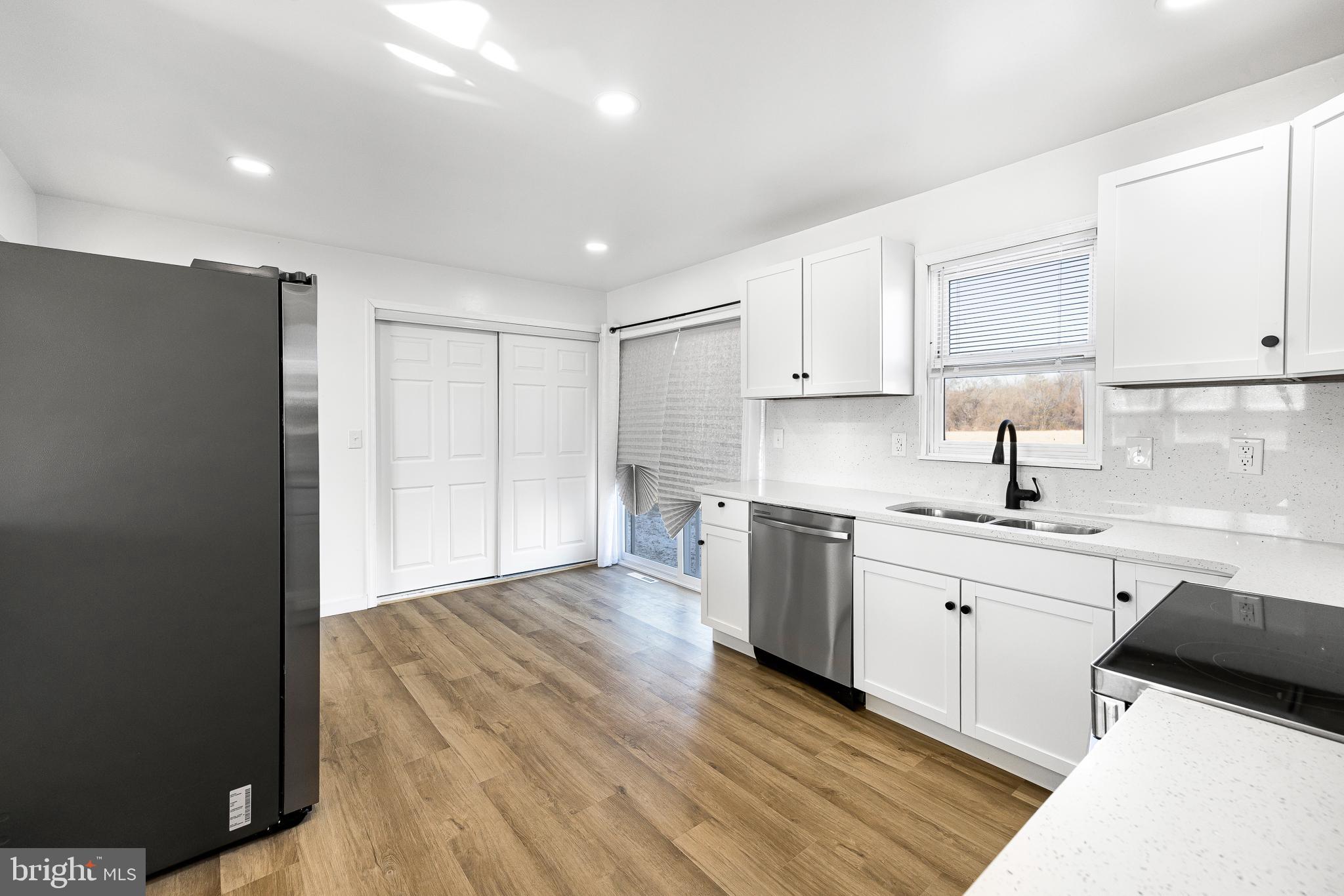22041 Neal Road Lincoln, DE 19960 - Photo 10 of 28 a kitchen with granite countertop a sink cabinets and stainless steel appliances