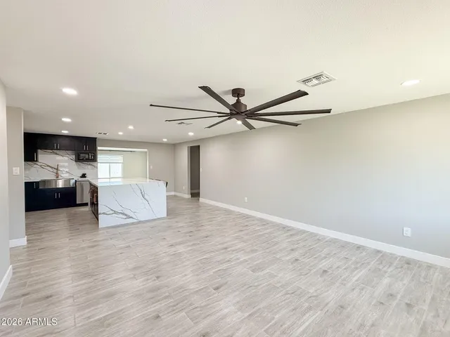 a view of a livingroom with a furniture and a ceiling fan