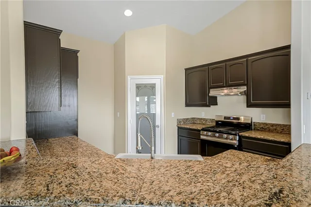 a kitchen with stainless steel appliances a stove and a refrigerator