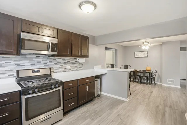 a kitchen with a stove a sink and a microwave