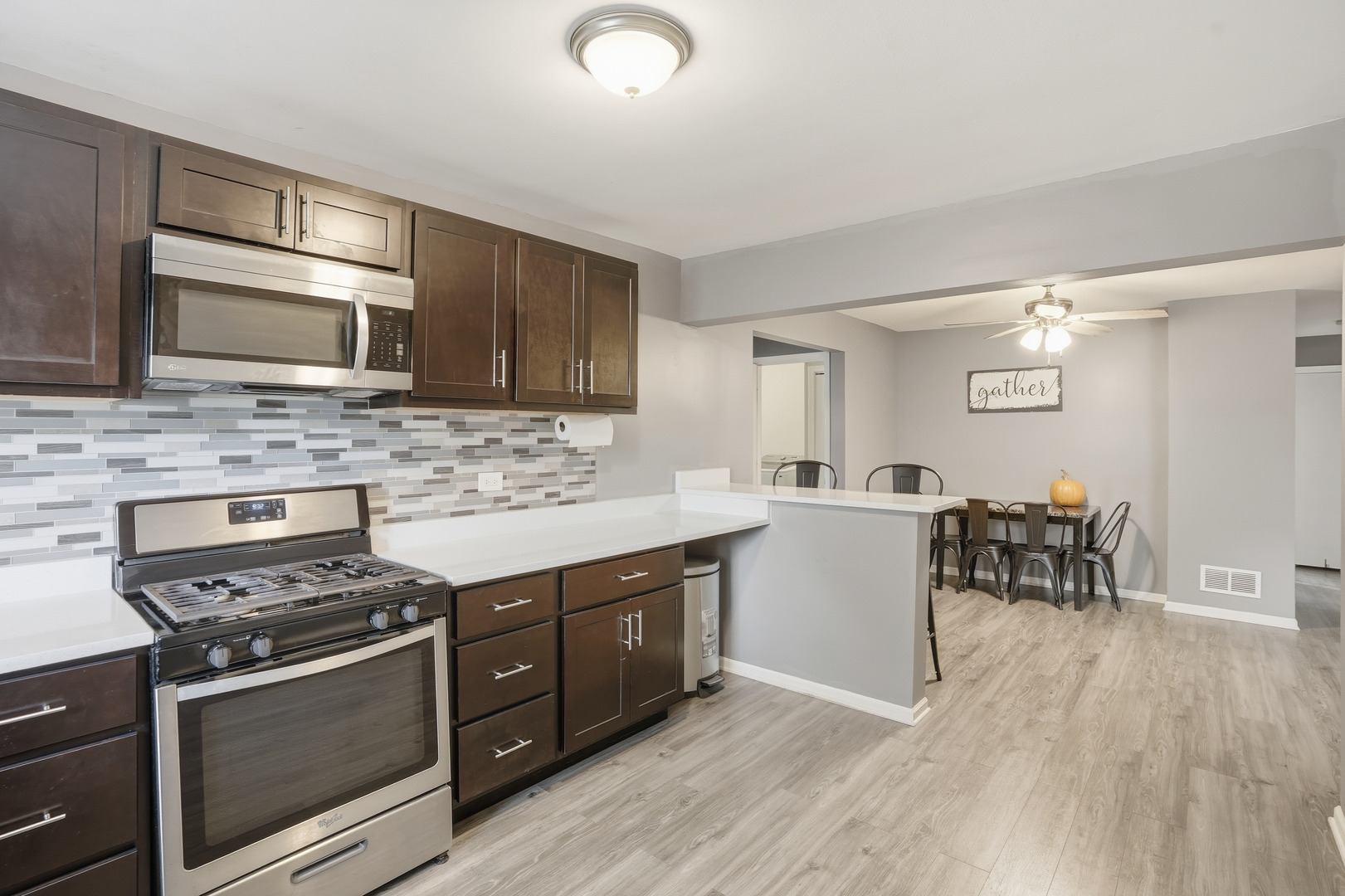 515 West Auburn Lane Crete, IL 60417 - Photo 2 of 20 a kitchen with a stove a sink and a microwave