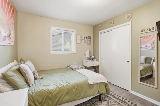 a bedroom with a bed and hallway