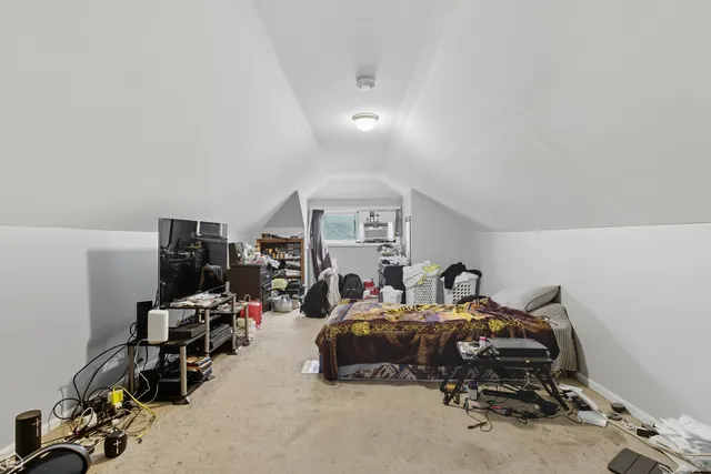 a bedroom with furniture and a gym equipment