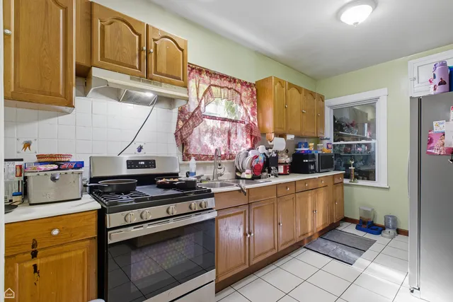 a kitchen with stainless steel appliances granite countertop a stove and a refrigerator