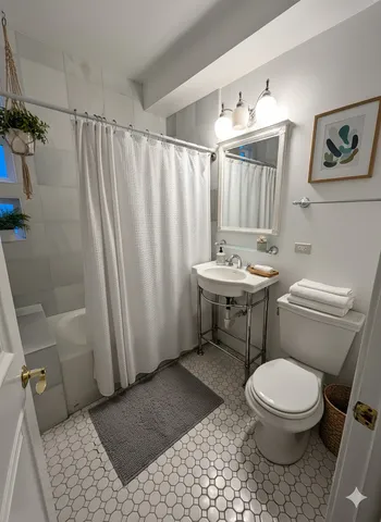 a bathroom with a toilet a sink and a shower