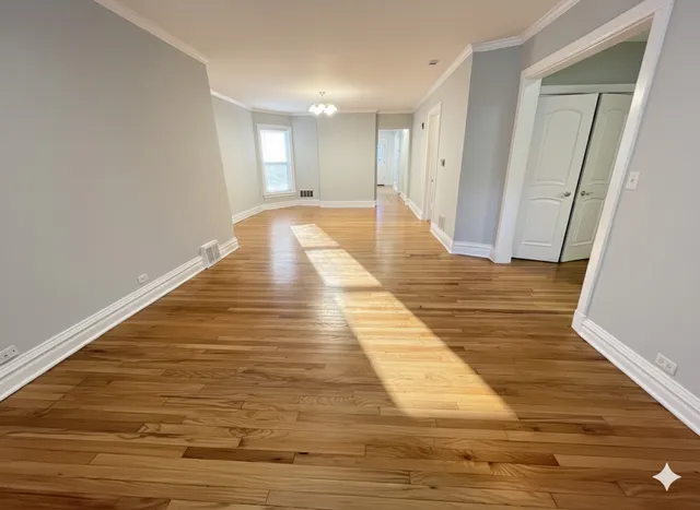 a view of a room with wooden floor