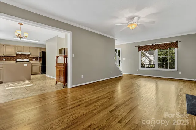 a view of a kitchen with wooden floor and a window