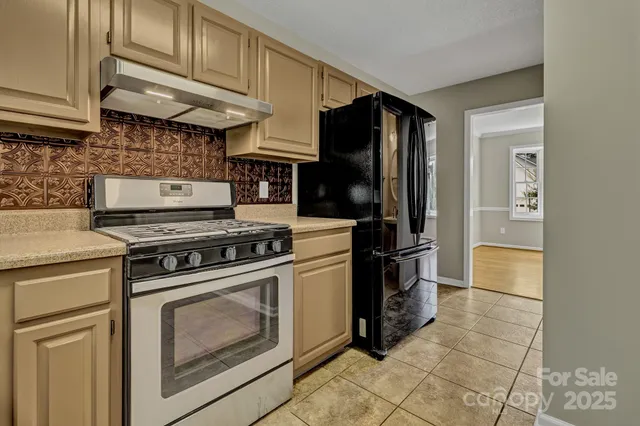 a kitchen with a stove top oven and cabinets