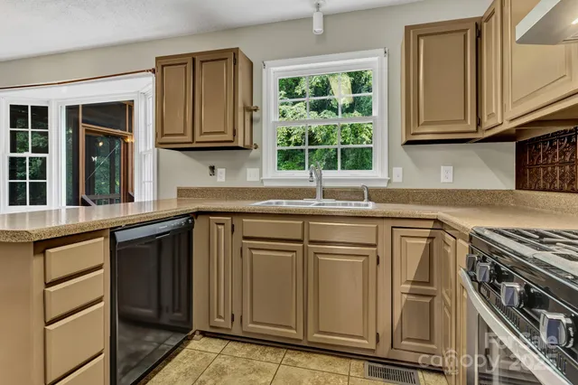 a kitchen with stainless steel appliances granite countertop a stove and a sink