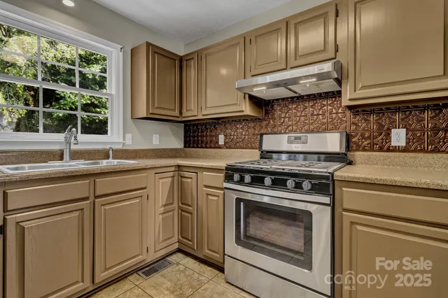 a kitchen with cabinets appliances and a sink