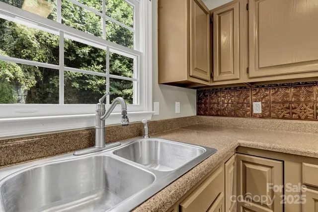 a kitchen with granite countertop a sink and a window