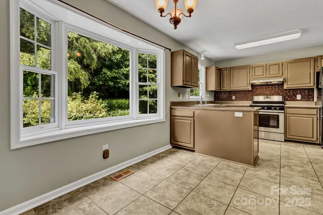 a kitchen with stainless steel appliances granite countertop a stove sink and microwave