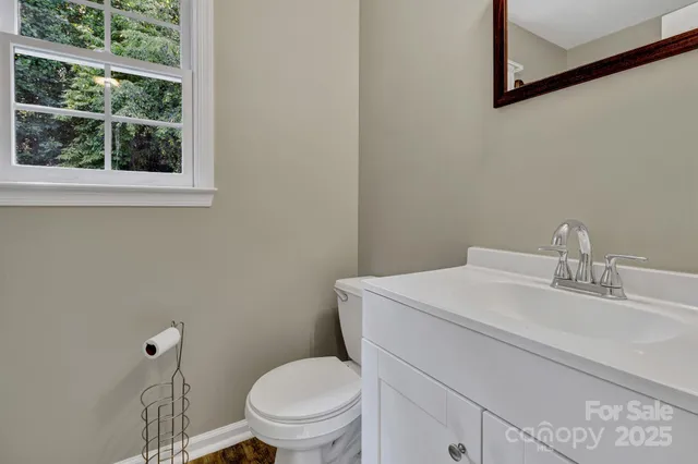 a white toilet sitting next to a bathroom sink