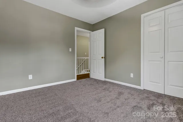 a view of an empty room with closet area