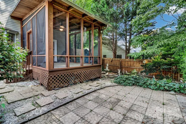 a view of a house with a small yard and wooden fence