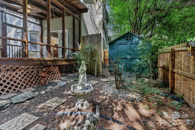 a backyard of a house with lots of green space and glass windows