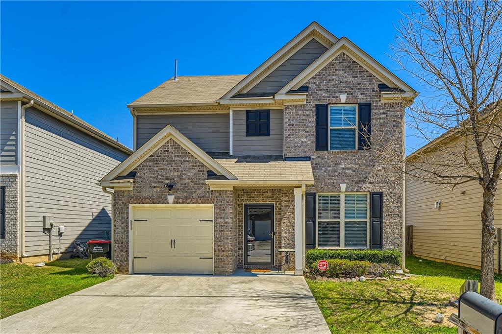 5883 Little River Road Atlanta, GA 30349 - Photo 1 of 1 a view of a house with a small yard and a large tree