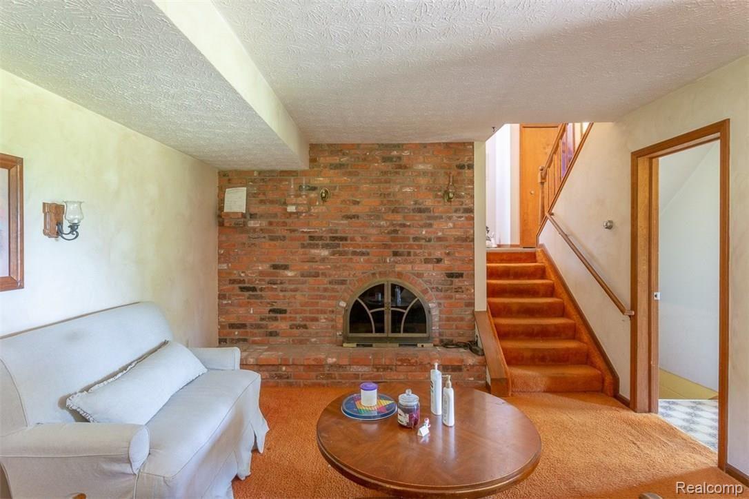 3440 North Hickory Ridge Road Highland, MI 48357 - Photo 31 of 43 LOWER LEVEL FAMILY ROOM WITH FIREPLACE