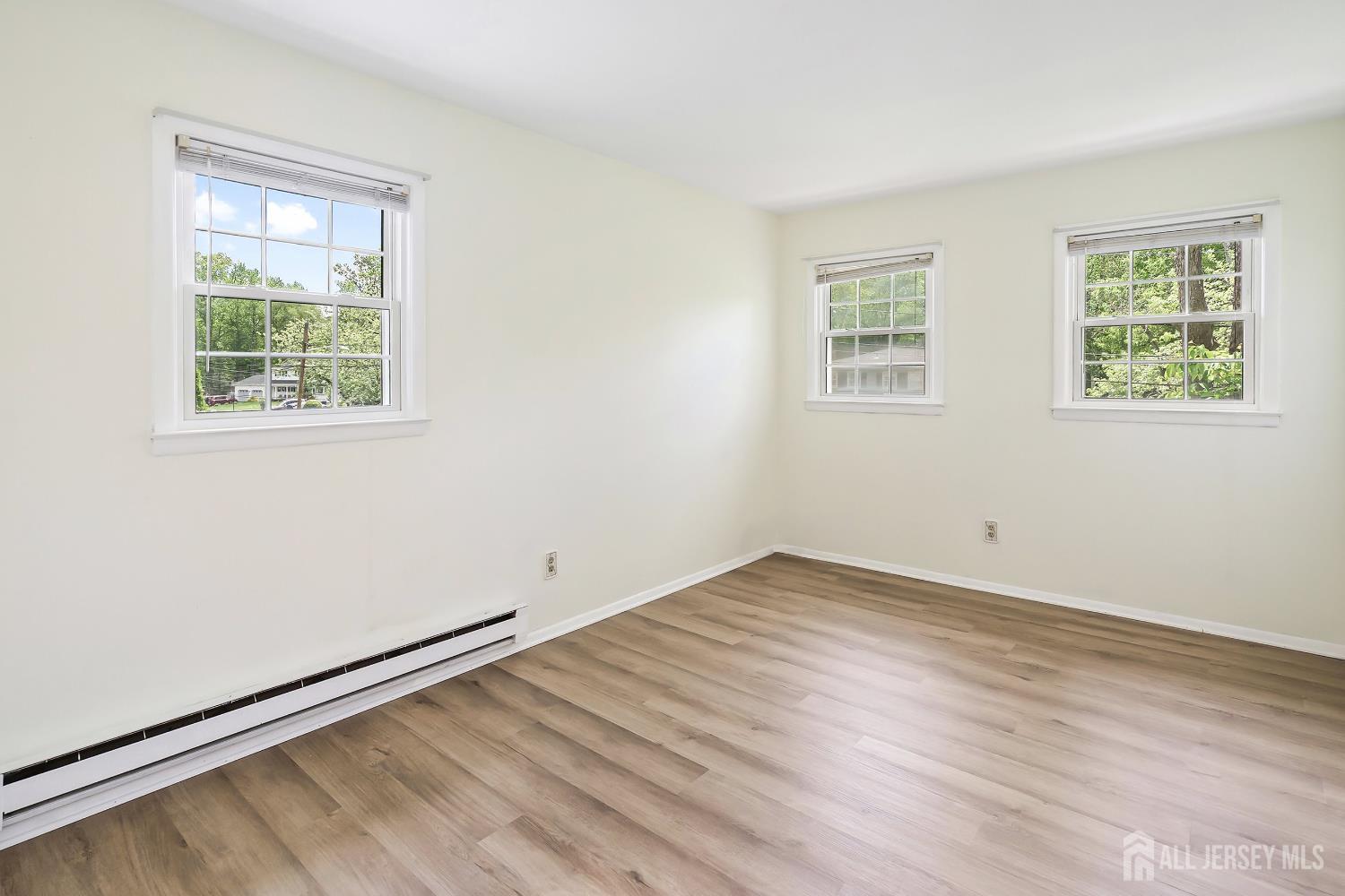 10 Woodruff Road Edison, NJ 08820 - Photo 13 of 18 an empty room with wooden floor and windows