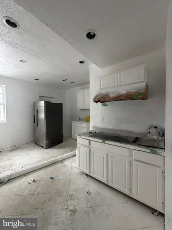 a kitchen with granite countertop a sink and a stove top oven