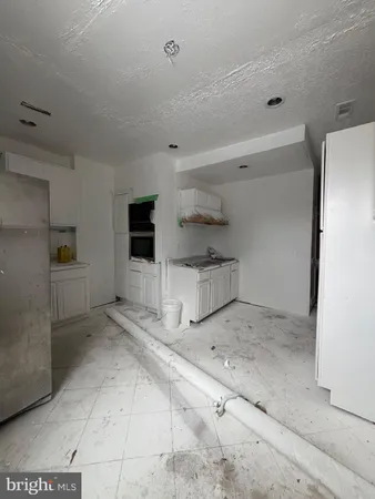a view of a refrigerator and more cabinets