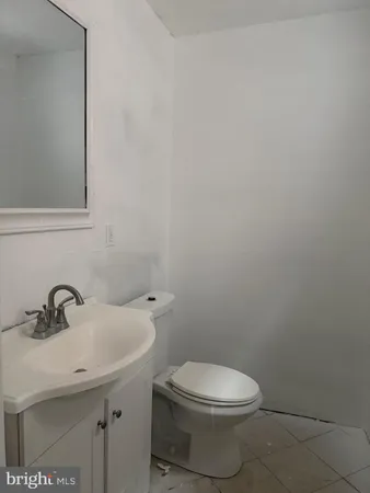 a bathroom with a sink a toilet and mirror