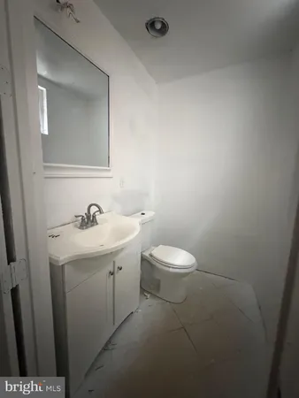 a bathroom with a sink a toilet and mirror
