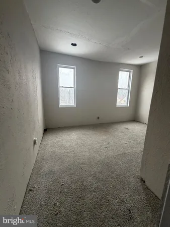 an empty room with a empty space and windows