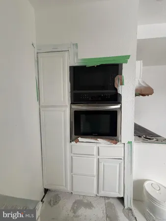 a kitchen with a stove and a microwave