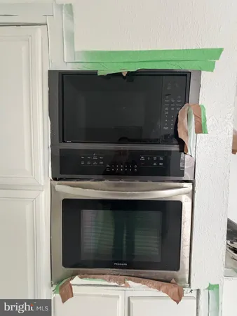 a bathroom with a stove and a microwave