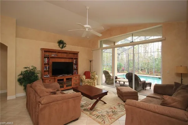 a living room with furniture fireplace and a large window