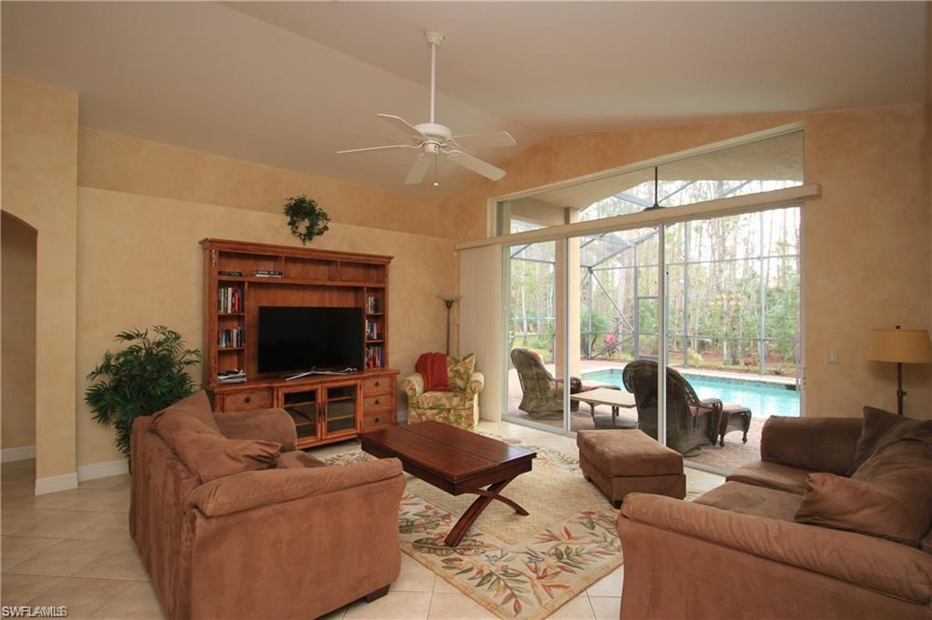 2322 Butterfly Palm Drive Naples, FL 34119 - Photo 15 of 32 a living room with furniture fireplace and a large window